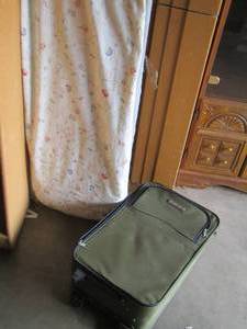 lot 40 image: ironing board- green suitcase