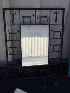 lot 67 image: Wall mirror with stick figures around frame, different but neat