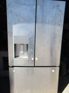 lot 10 image: GE REFRIGERATOR Stainless steel -  bottom freezer 2 door fridge with water and ice dispenser needs handles but has built in handles at top of each drawer, works needs wiped out