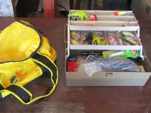 lot 209 image: tackle box with various fishing supplies and a yellow bass pro bag