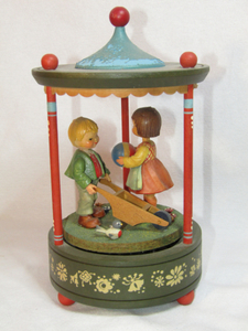 lot 123 image: Thorens Swiss movement Hand-carved Schmid Anri with little boy and girl with wheel barrow music box