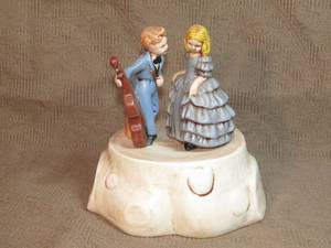 lot 132 image: Swiss made Ceramic music box girl and boy with Cello
