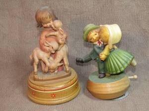 lot 148 image: Reuge, Anri, Juan Ferrandiz signed Hand-carved Lullaby music box with Swiss movement, and Schmid Dancing Couple Swiss made music box