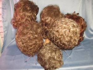 lot 394 image: Assortment of Wigs in browns and auburns, includes metal & wicker display heads