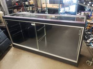 lot 358 image: Large Rolling Glass Display Case.  Includes 4 Glass Shelves (Not Pictured) Cabinet is Locked.  NO KEYS.