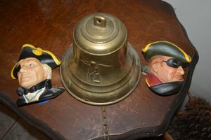 lot 4 image: Nautical Brass bell with Bosson Chalkware heads