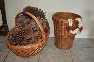 lot 8 image: Basket with large pine cones and basket weave trash bin