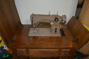 lot 17 image: Vintage SINGER sewing machine and table model 105010