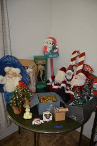 lot 22 image: Christmas decorations with porcelain angel, plush and wood santas, animated figurine and more