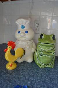 lot 68 image: Cookie jars (Frog and Pillsbury Dough boy) and ceramic chicken (has Goebel stamp)