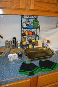 lot 84 image: Misc. kitchen items - Pyrex baking dishes, ceramic fruit and veggie shaped lidded jars, wire rack, salt and pepper shakers and more