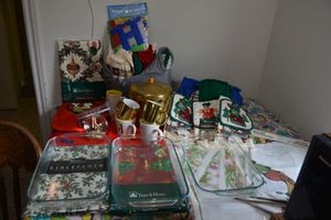 lot 98 image: Christmas and holiday lot - baking dishes, tablecloths, unused holiday kitchen towel sets, Brass ice bucket, mugs, and more