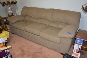 lot 155 image: Tan upholstered couch. Cushions have velcro to stay in place, corner feet are plastic