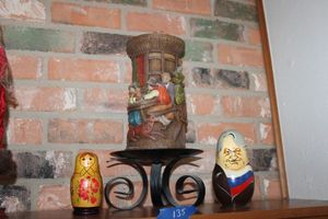 lot 135 image: Russian nesting dolls and German figure candle