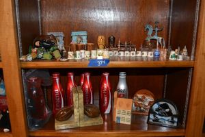 lot 374 image: Misc. souvenirs and thimbles, empty Coke cans, marble football bookends