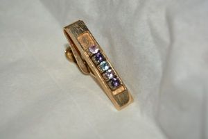 lot 492 image: Jewelry Tie clip marked 969 JTC 10K with what appear to be birthstones - Untested - Please Preview