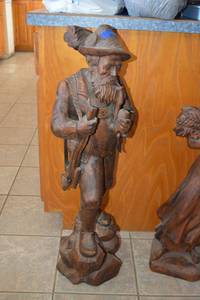 lot 102 image: Wooden man statue (about 3 ft tall, part of rifle is being reglued)