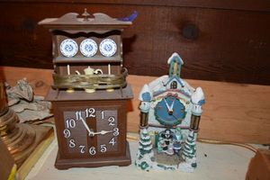 lot 529 image: Plastic clock and resin clock as shown