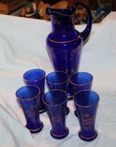lot 621 image: Blue glass with gold accents pitcher and glass set