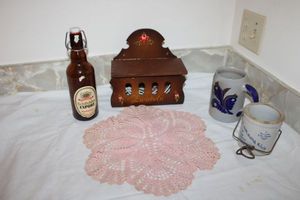 lot 610 image: European wood box, beer bottle, butter jar, and mug as shown
