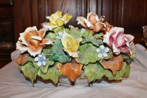 lot 701 image: Porcelain floral basket with sticker Handarbeit stamped made in Italy - Possibly Capodimonte 11long x 10tall.