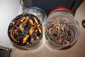 lot 679 image: 2 tins with dried peppers and fruit