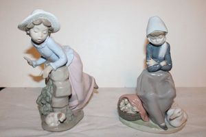 lot 696 image: Lladro Duck Seller and NAO Girl Leaning over Stone Wall figurines