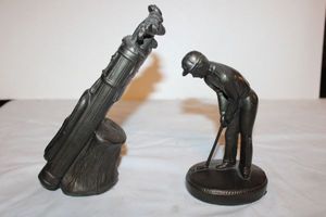 lot 699 image: Golfer and golf bag statues