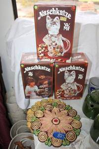 lot 827 image: (3) clear glass candy pitchers (still in boxes) plus wicker trivets