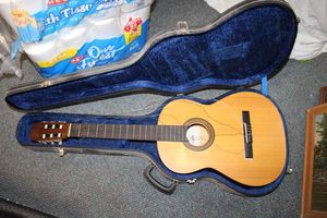 lot 945 image: Aria Guitar with case (needs string repair)