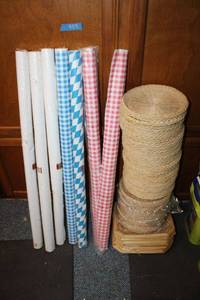 lot 988 image: Wicker plate holders and plastic table cover rolls