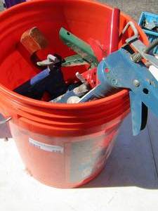 lot 238 image: bucket of caulking guns