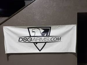 lot 1059 image: White All Weather DSG Badge Logo Banner w Eyelets.  Measures 8 x 3