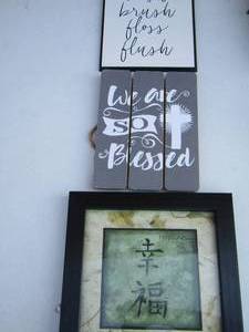 lot 40 image: We are so blessed wall art, happiness wall art, wash blush floss flush wall art