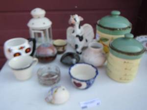 lot 47 image: canisters, cow figurine with angel wings, coffee cups, and various home dcor