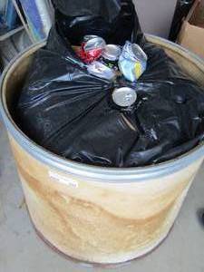 lot 204 image: bucket of smashed aluminum cans