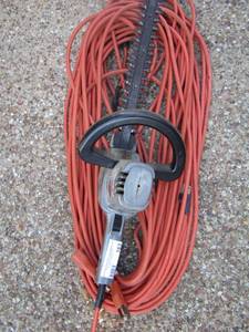 lot 162 image: Hedge trimmer with a long orange extension cord