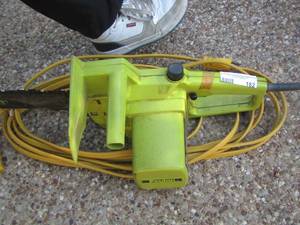 lot 163 image: Poulan Green CHAIN SAW and yellow extension cord