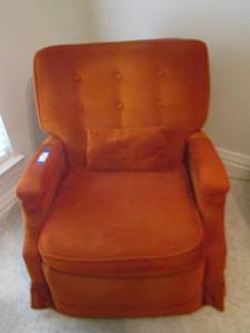 lot 331 image: the mystery chair orange in color and reclines