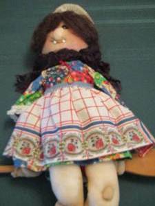 lot 382 image: stuffed doll sitting on a wooden stick