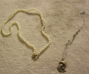 lot 42 image: double dolphin necklace, pearl necklace