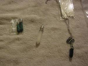 lot 57 image: necklace with a black sparkly crystal, white crystal, 2 crystal turquoise earrings