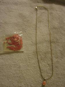 lot 65 image: gold necklace with a pink rose, small bag of beads