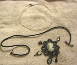 lot 89 image: CAMEO DROP WITH CHARMS ATTACHED