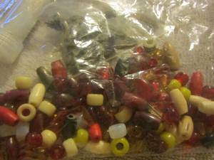 lot 119 image: various size beads for necklaces, thread needles, skull and feather necklaces