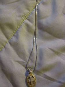 lot 356 image: silver chain with a gold pendant