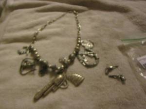 lot 48 image: Decorative necklace with western dcor with shotgun earrings