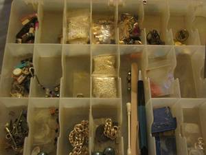 lot 454 image: container full of jewels, shirt pins, bracelet and jewelry making stuff