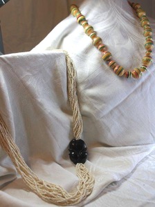 lot 21 image: Multi strand torsade necklace with carved Jet or Onyx incorporated pendant. Spring ring clasp. 28L. Marquetry wood color strip bead necklace. Spring ring clasp. 28L