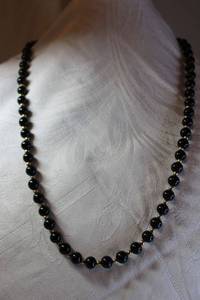 lot 24 image: 14K Gold jewelry Polished jet black bead necklace with gold station balls and 14K yellow gold clasp. Clasp marked 14K. 28L